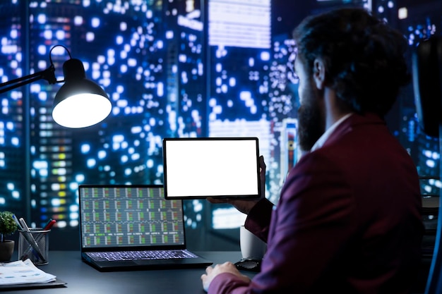 A network security engineer working at a workstation, with multiple monitors displaying network traffic and security logs. The background shows a secure data center environment.