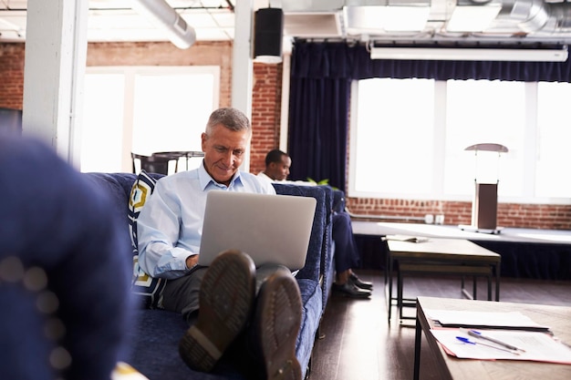 A veteran entrepreneur working on a laptop in a modern co-working space, illustrating the opportunities for veteran-owned businesses.