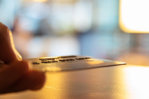 A close-up image of a hand holding a check with a blurred background of an office setting, symbolizing unclaimed funds and financial opportunities.